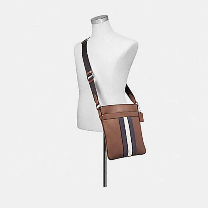 Coach charles crossbody with top varsity stripe