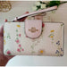 COACH Tech Phone Wallet in Signature Canvas with Spaced Wildflower - www.lasevgi.com